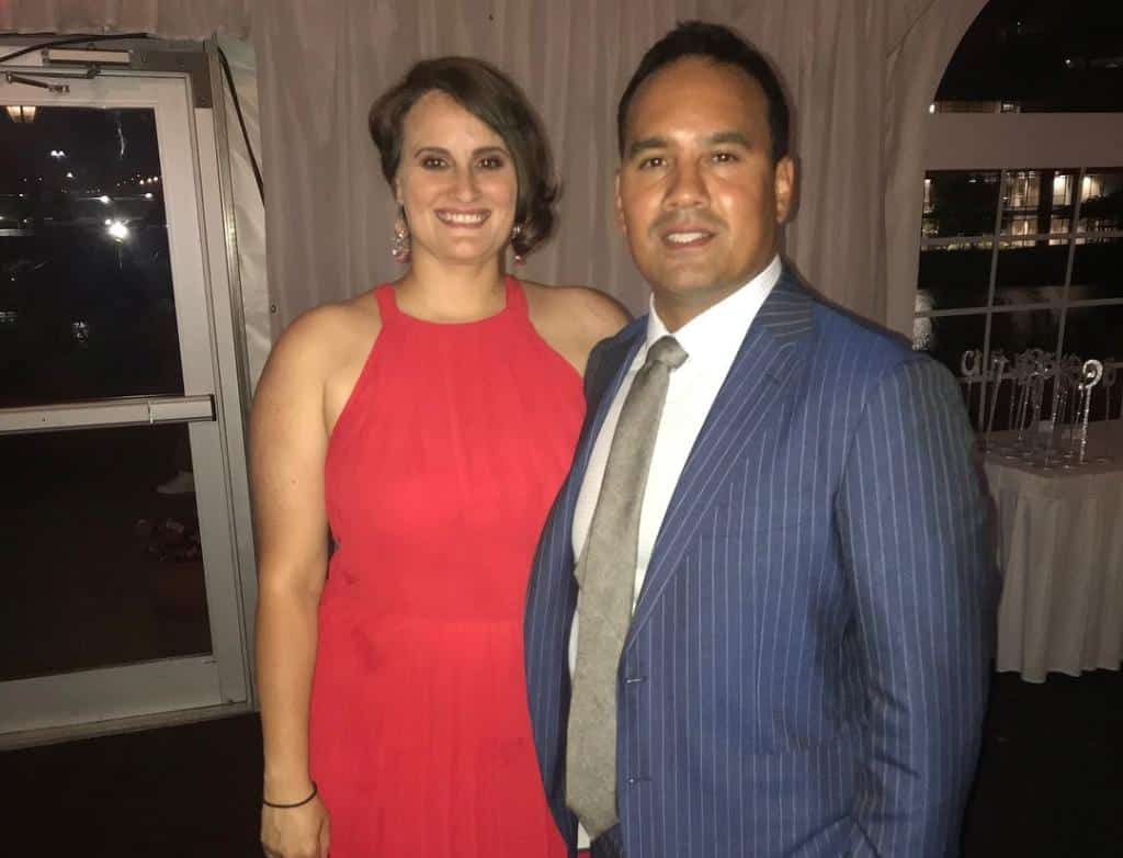 Emily and Samuel Alvelo stand next to each other, smiling