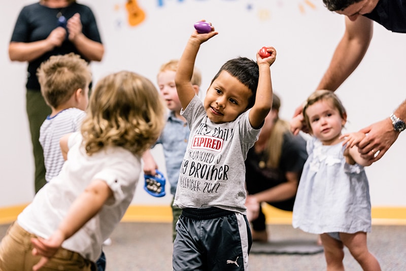 A young student in an early childhood class celebrating