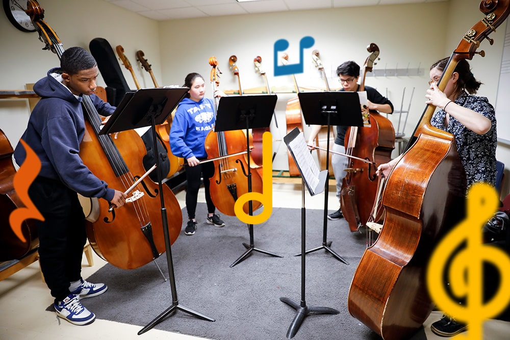 A quartet of bass players rehearsing in a group class