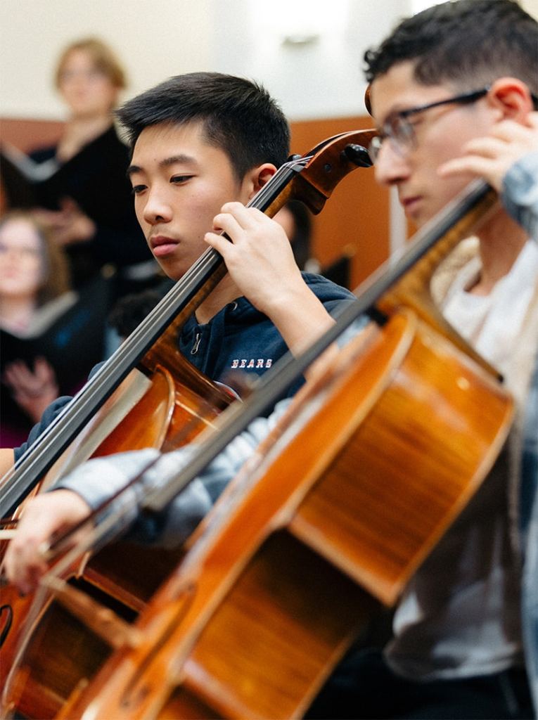 Conservatory cello players during a performance