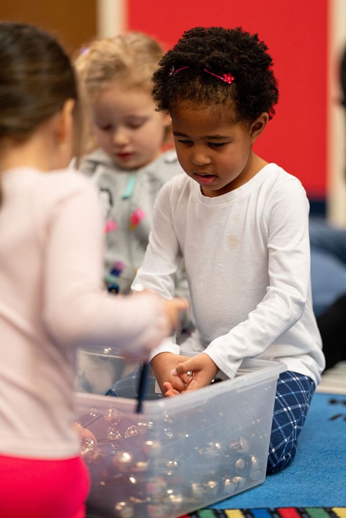Young students in an early childhood class selecting an instrument