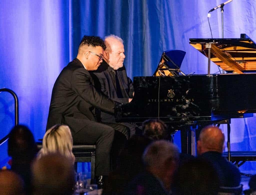 Josh Mhoon and Emanuel Ax play a piano duet onstage