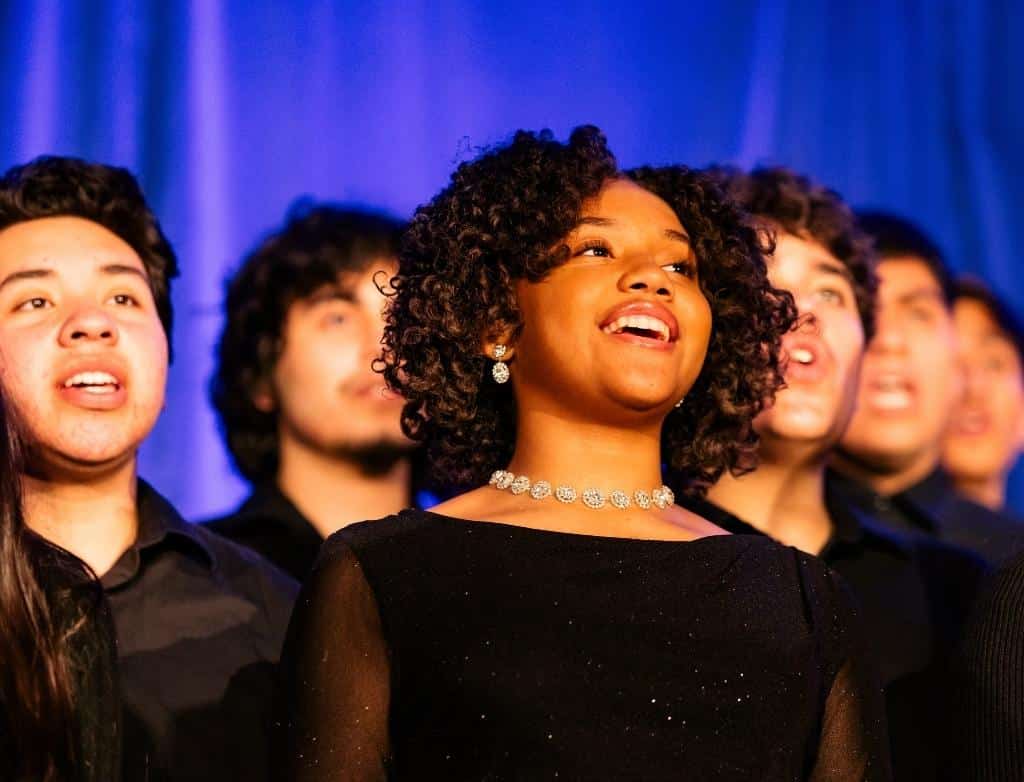 Students sing in choir onstage