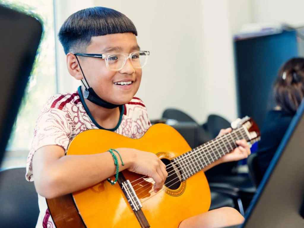 Guitar student in group music classes