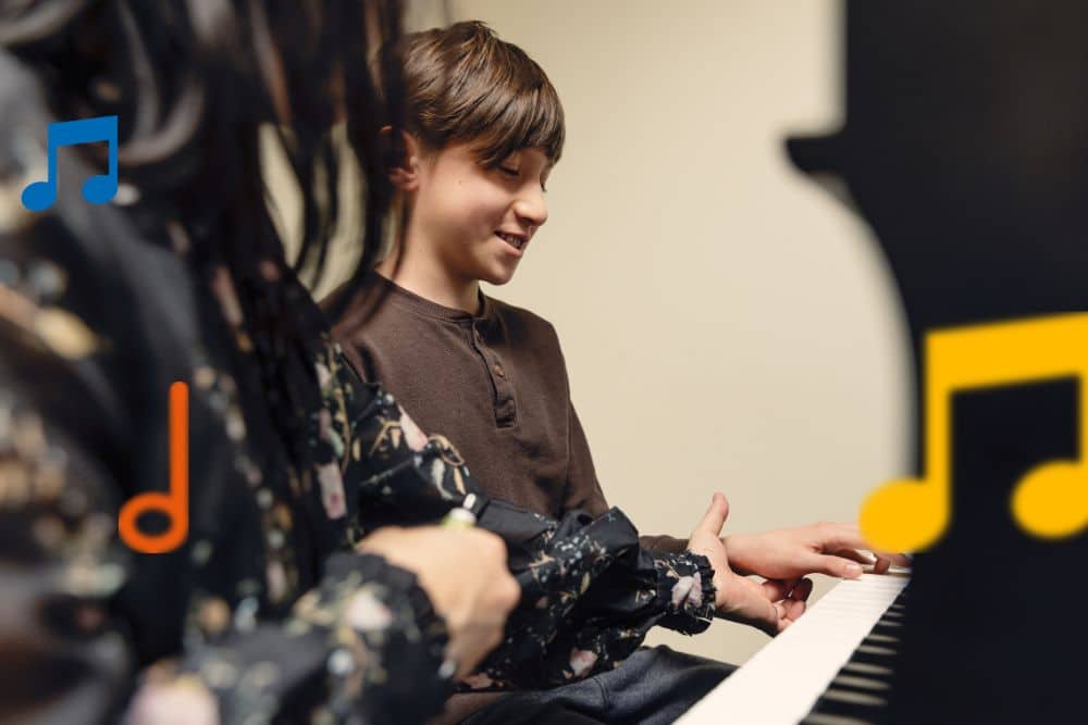 A young piano student receiving instruction from her instructor