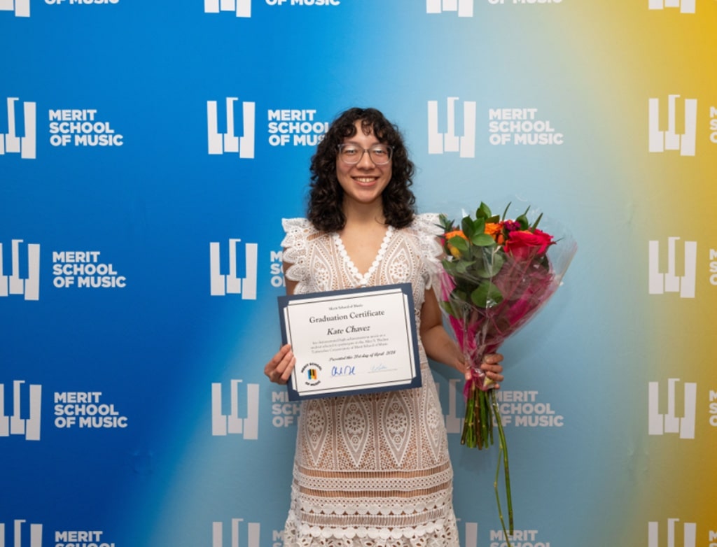 Kate Chavez holding a diploma and flowers.