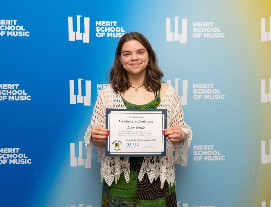 Lucy Forde holding a diploma.