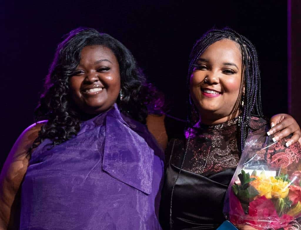 Mae Ya Carter Ryan and Alexis Lombre smile posing together