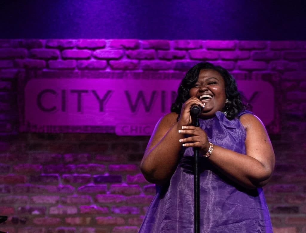 Mae Ya Carter Ryan singing at a microphone