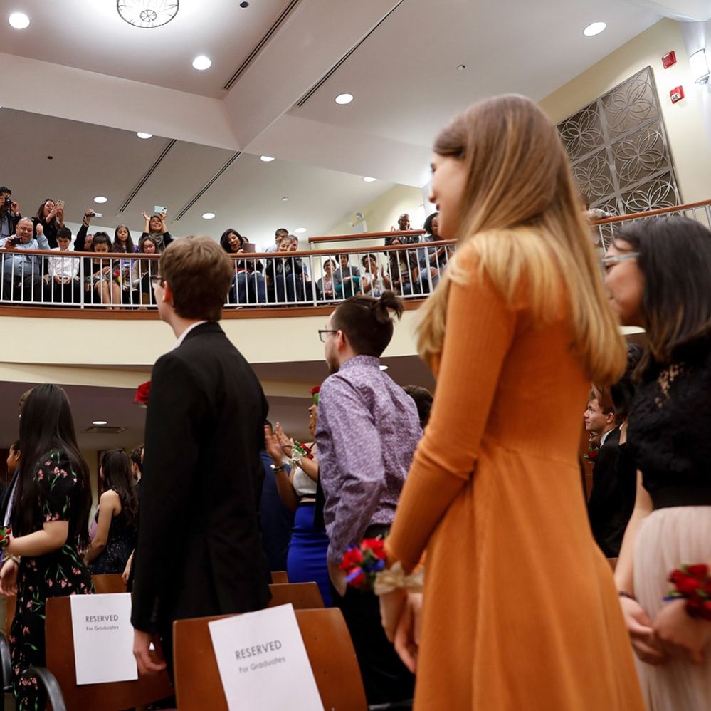 Merit students on their graduation day receiving applause