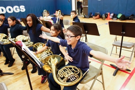 Horn players in an elementary school having fun with an exercise
