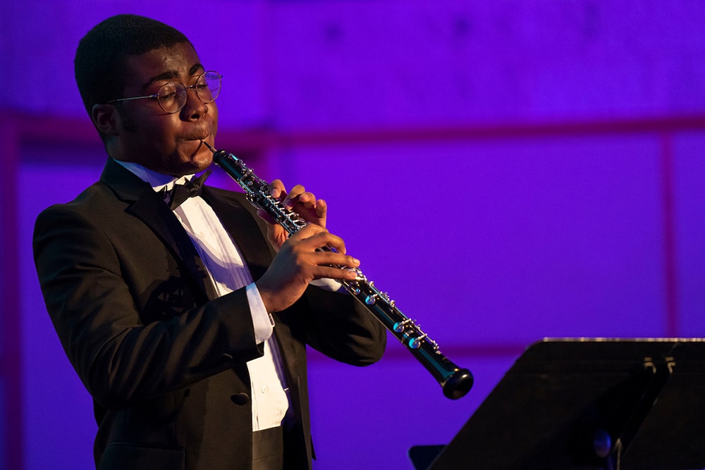 An oboe player performing a solo