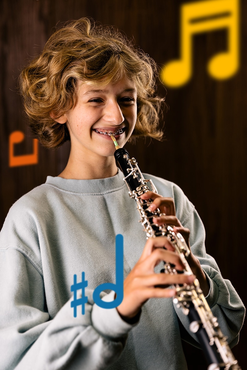 An oboe player is all smiles before playing her instrument