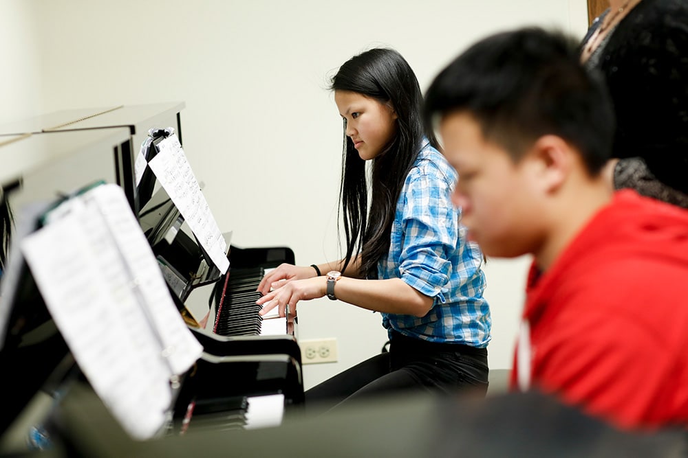 Merit students in a group piano class