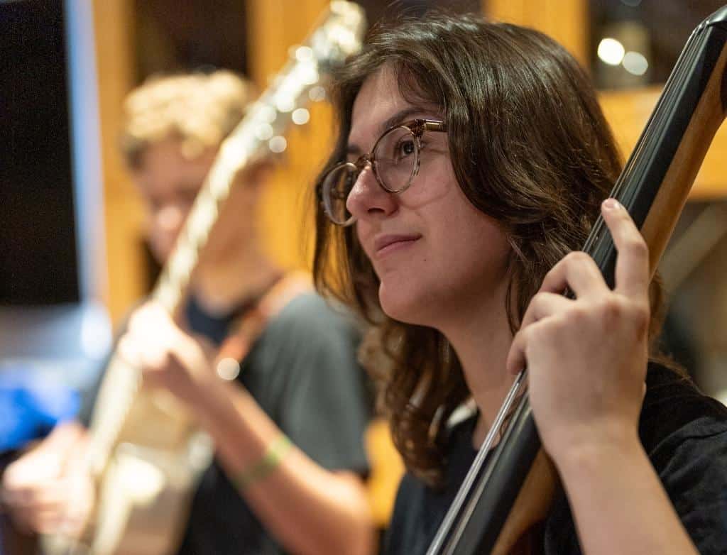 A student playing bass