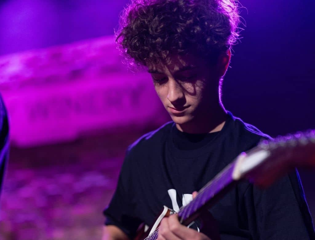 A student playing electric guitar