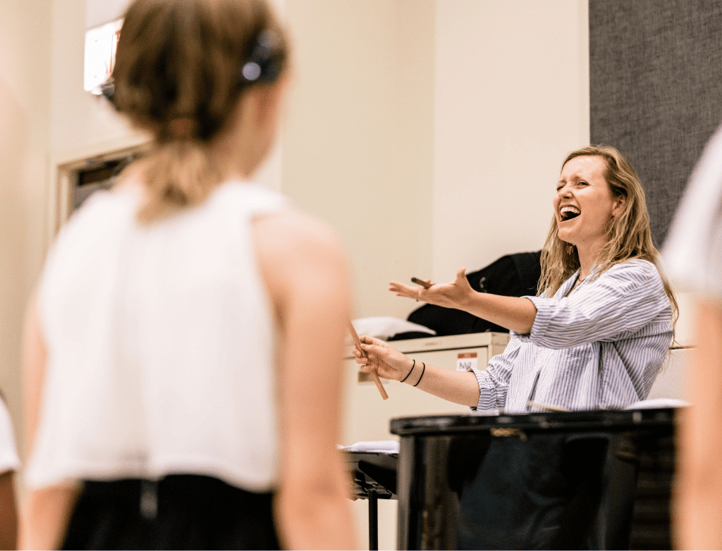 Director Carling Fitzsimmons conducts the choir.