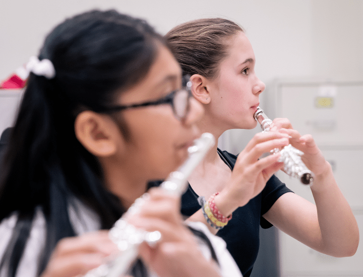 Two students play flute.