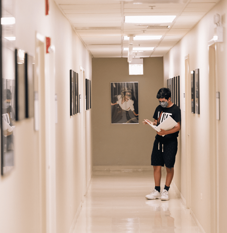 A merit student studying music in the hallway