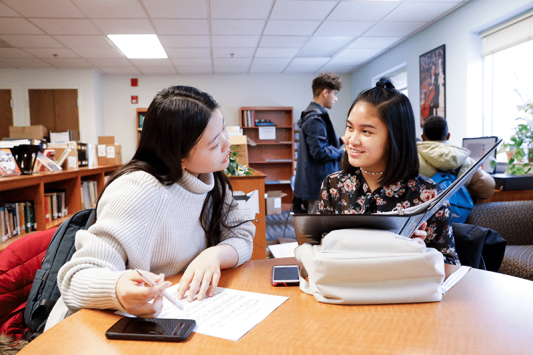 Two students studying sheet music together