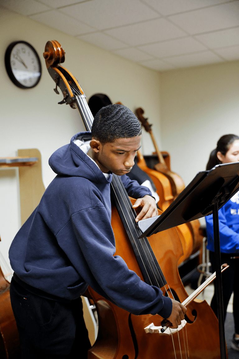A bass player taking a closer look at his sheet music